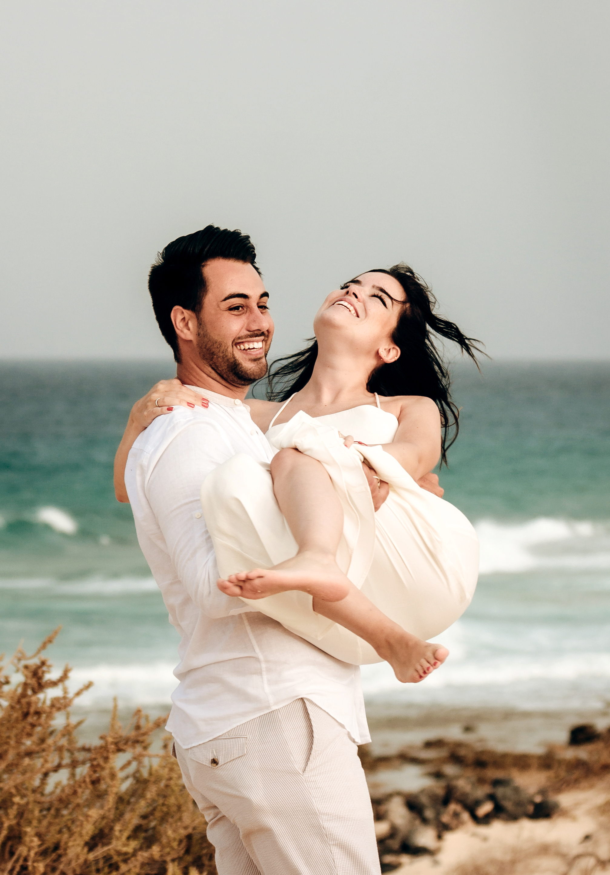Fuerteventura beach proposal: Couple captured in stunning moment of man proposing to future wife on Grandes Playas - Dunes of Corralejo beach by professional photographer
