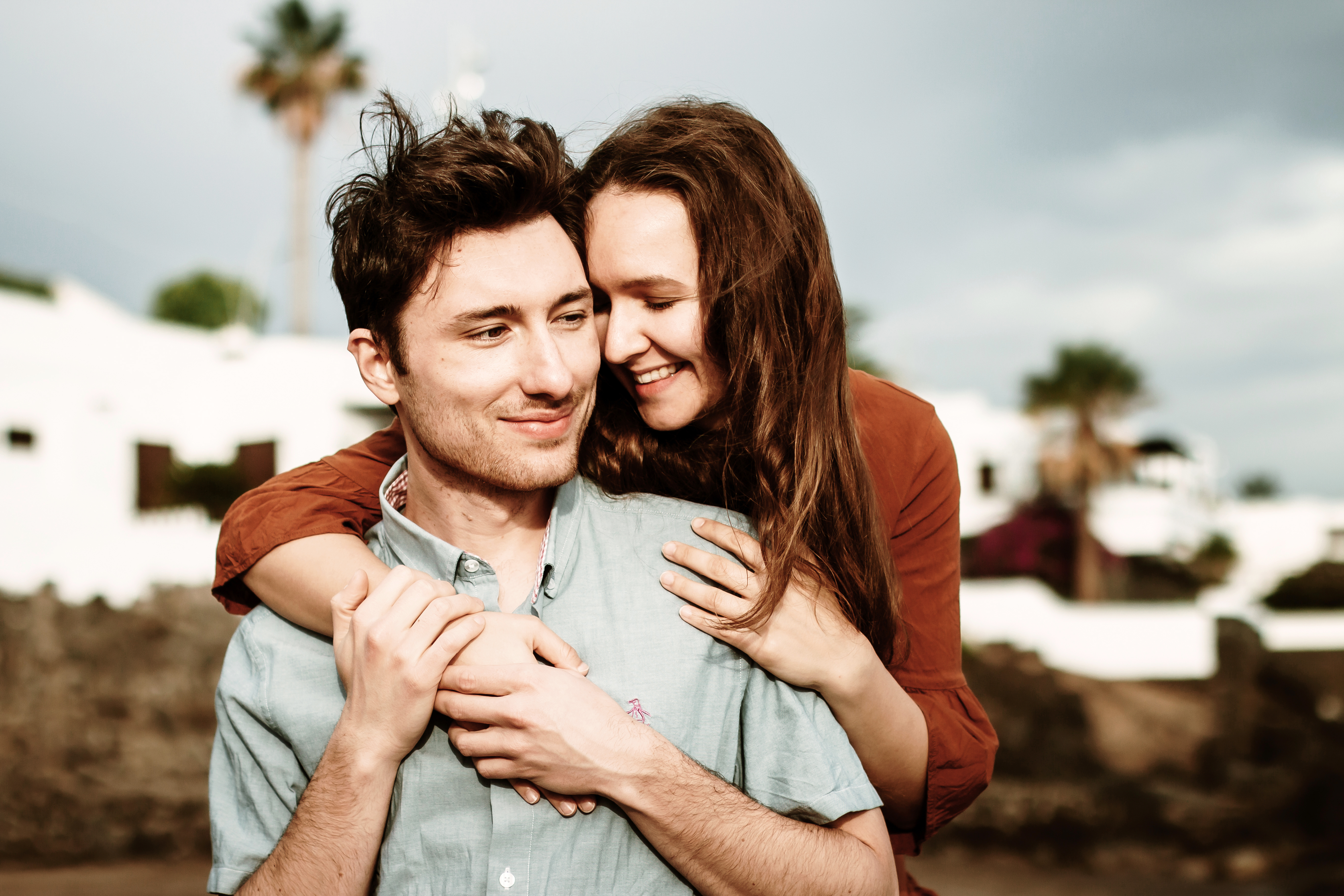 Lanzarote winter beach photo shoot: Couple captured in lovely and passionate sunset photo shoot on Puerto del Carmen beach by professional photographer