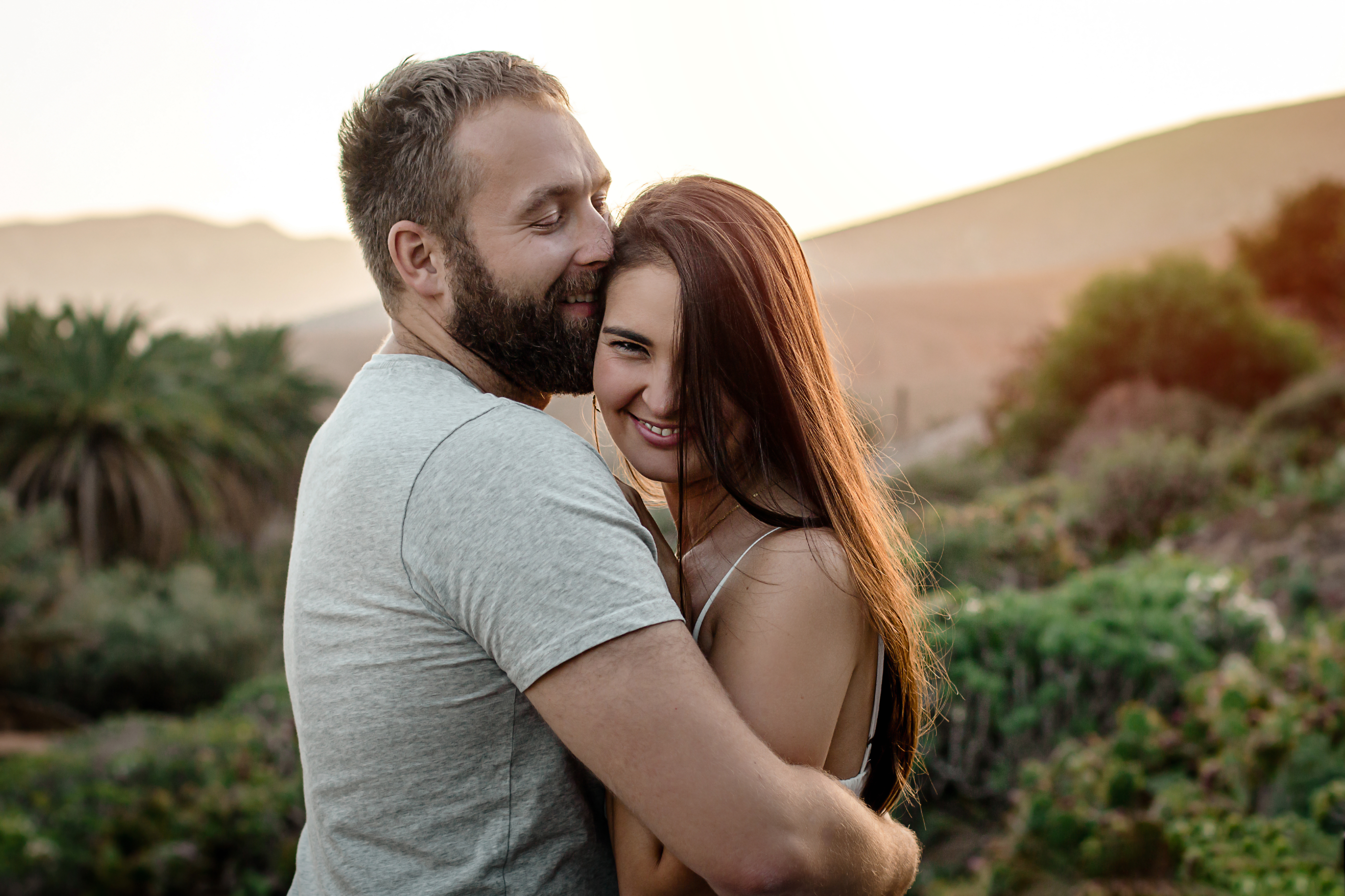 Lanzarote couple photography: Lovely couple shares gentle hug during sunset in Fuerteventura's Betancuria