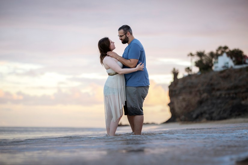 Romantic beach elopement in Fuerteventura – couple holding hands in shallow turquoise water